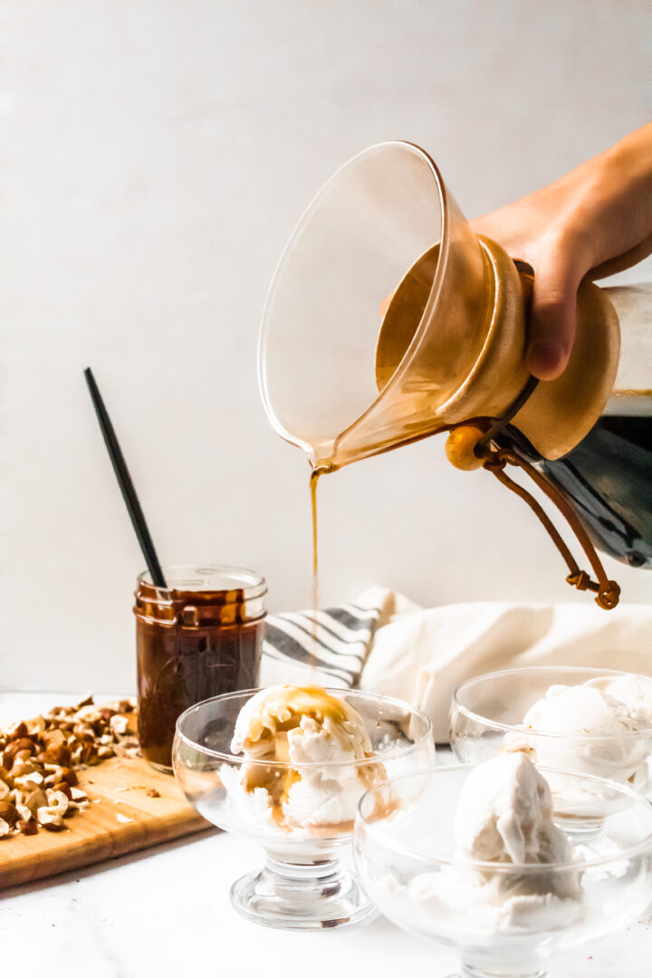 pouring coffee over ice cream for affogato