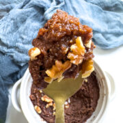 chocolate protein mug cake topped with homemade pumpkin butter and walnuts