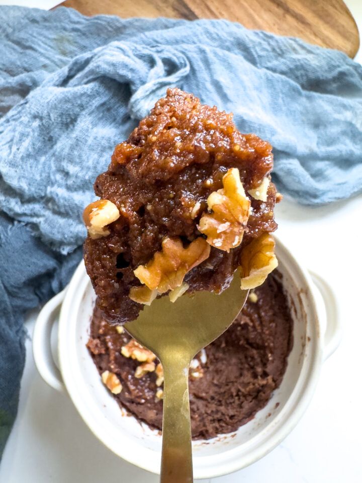 chocolate protein mug cake topped with homemade pumpkin butter and walnuts