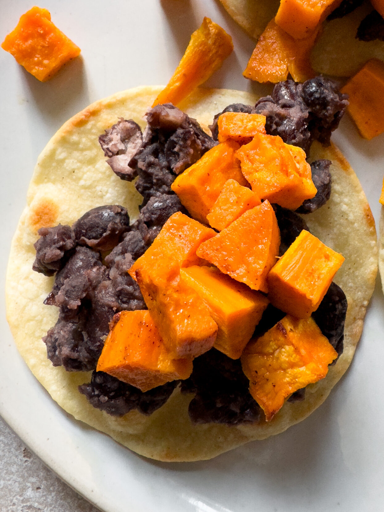 Add sweet potatoes to black bean tostada