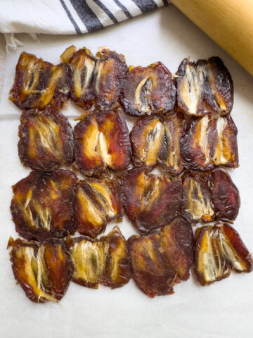 Dates pitted, halved and rolled out as the base of Dubai chocolate date bark. 
