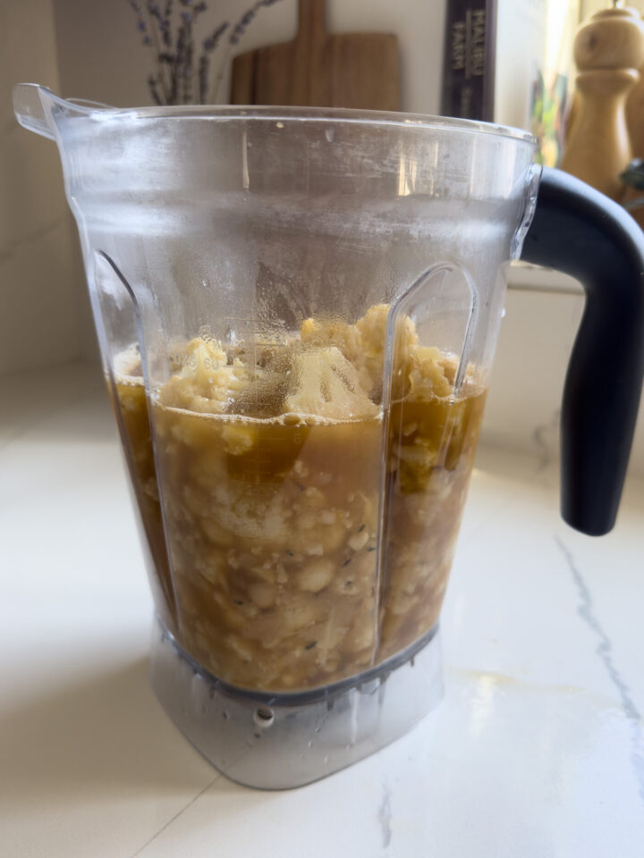 ingredients for soup in a blender before being blended.