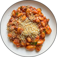 top down view of gnocchi with tomato sauce and parmesan