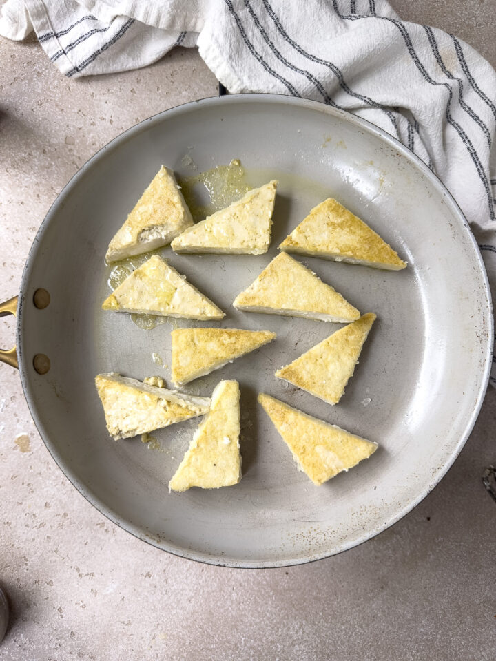 Browned tofu in pan for sticky tofu